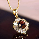 Ketting met bloempendant in goud en robijn
